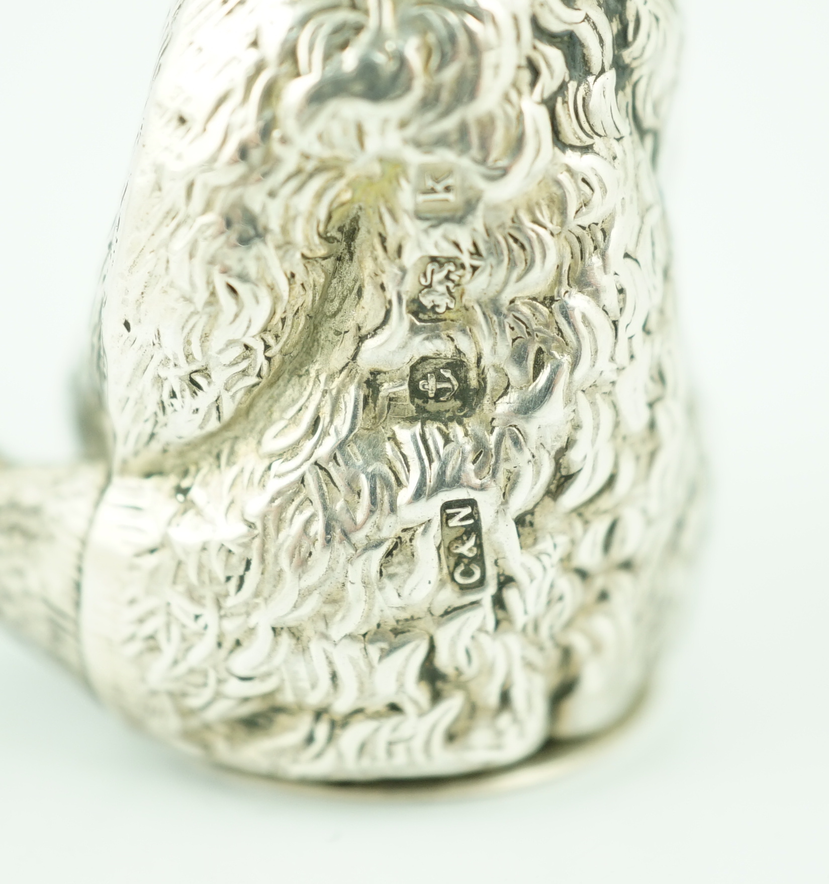 An Edwardian novelty silver pepperette modelled as a seated bear, Crisford & Norris